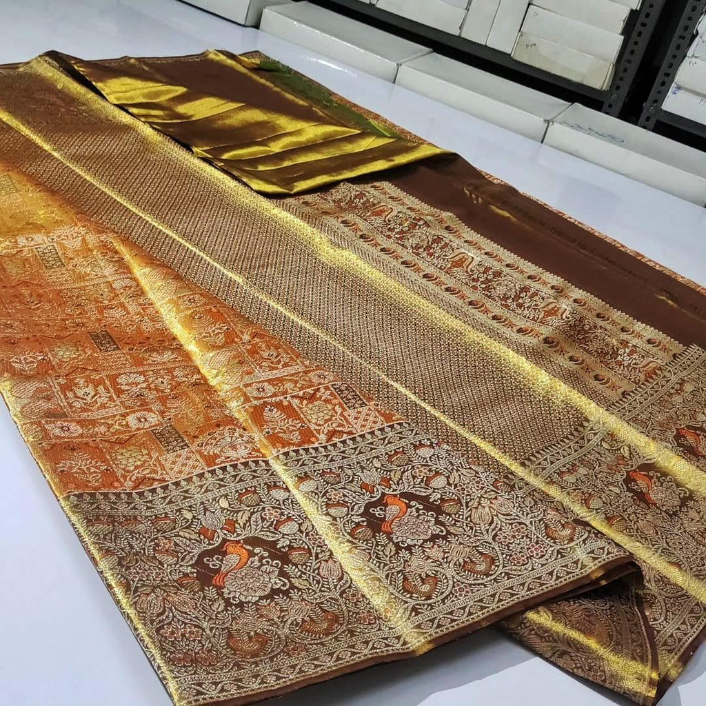 Orange Kanchipuram handloom 1G tissue silk saree with intricate meenakari brocade work and metallic zari borders, styled for a traditional South Indian wedding.