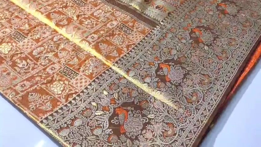 Orange Kanchipuram handloom 1G tissue silk saree with intricate meenakari brocade work and metallic zari borders, styled for a traditional South Indian wedding.