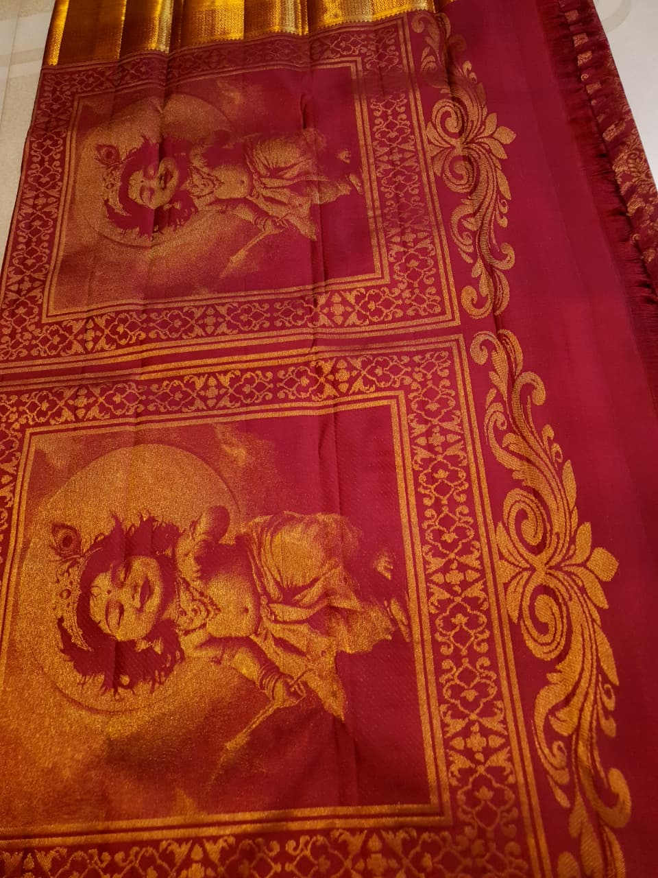 Red Kanchipuram handloom 2G gold pattu silk saree featuring intricate gold brocade weaving and a detailed Lord Murugan pallu.