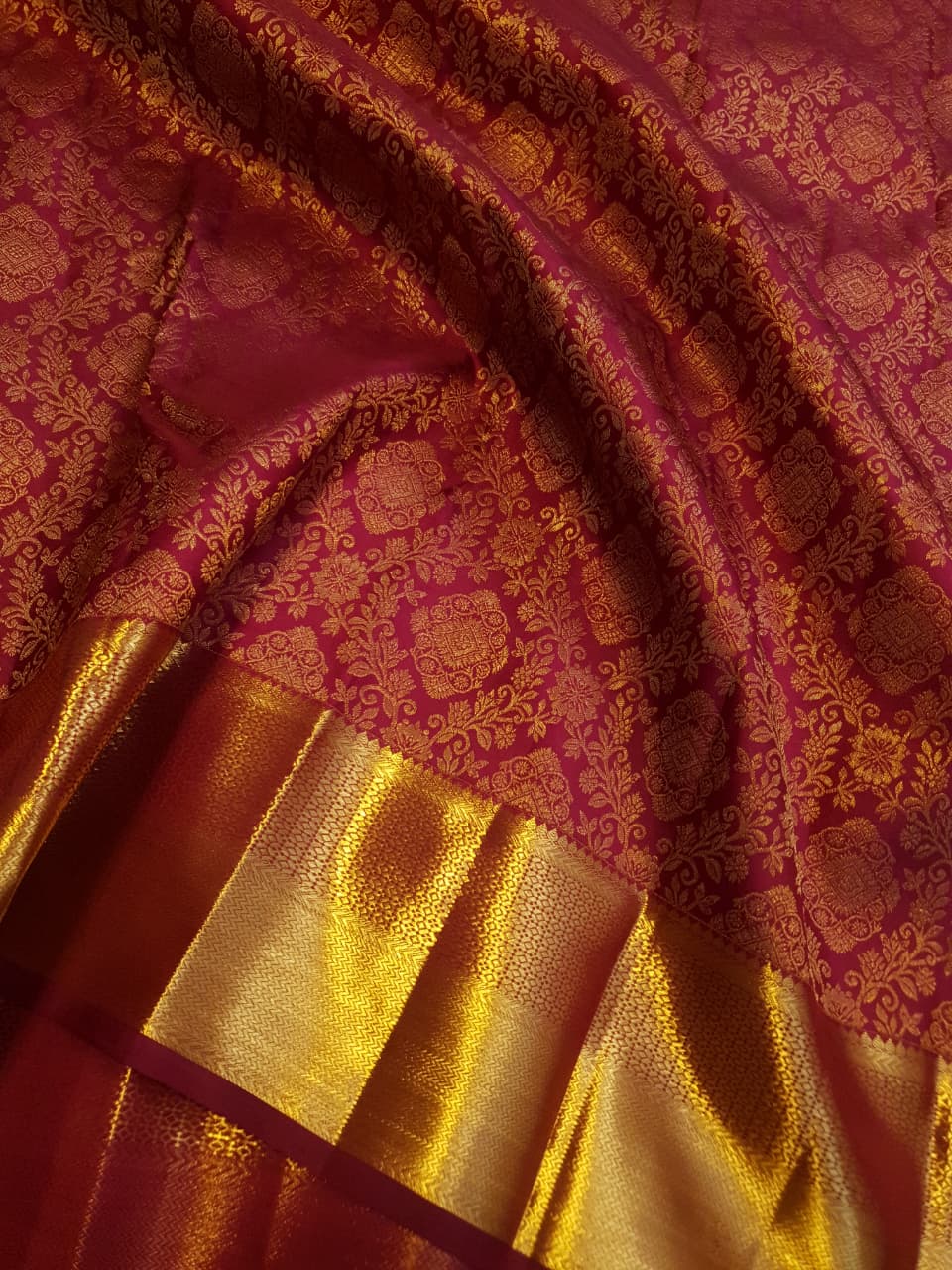 Red Kanchipuram handloom 2G gold pattu silk saree featuring intricate gold brocade weaving and a detailed Lord Murugan pallu.