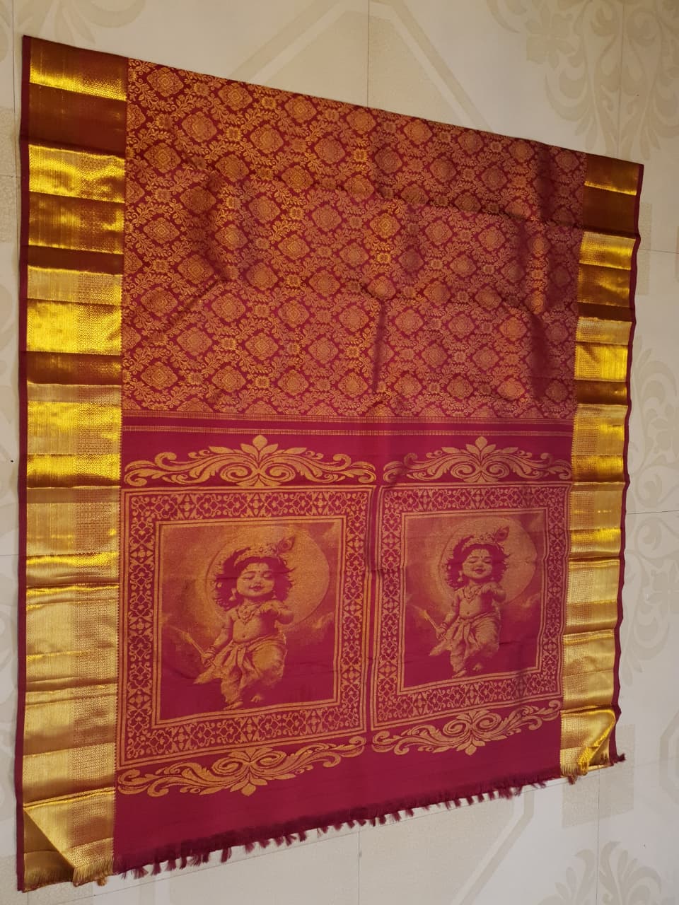 Red Kanchipuram handloom 2G gold pattu silk saree featuring intricate gold brocade weaving and a detailed Lord Murugan pallu.