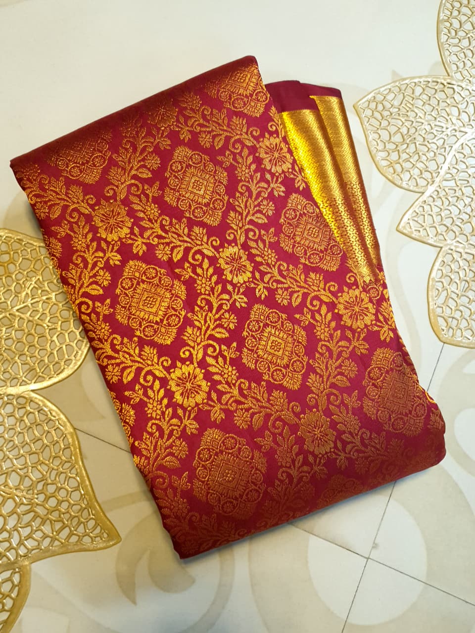 Red Kanchipuram handloom 2G gold pattu silk saree featuring intricate gold brocade weaving and a detailed Lord Murugan pallu.