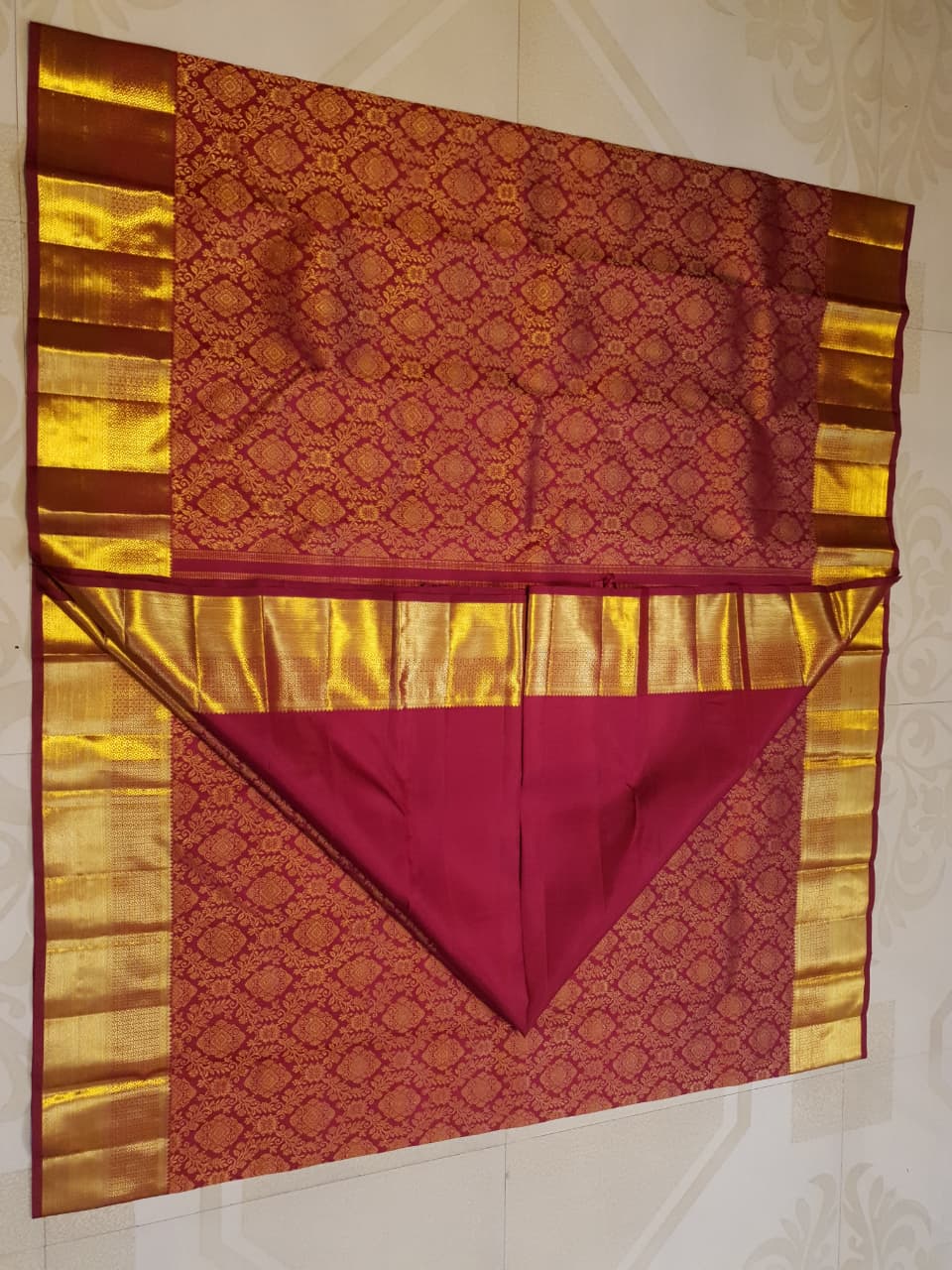 Red Kanchipuram handloom 2G gold pattu silk saree featuring intricate gold brocade weaving and a detailed Lord Murugan pallu.