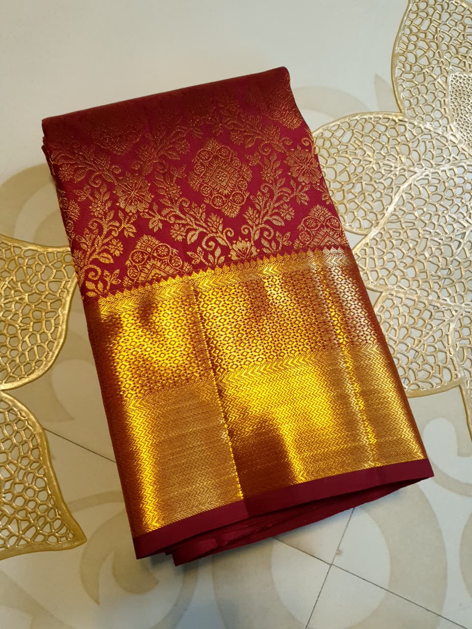 Red Kanchipuram handloom 2G gold pattu silk saree featuring intricate gold brocade weaving and a detailed Lord Murugan pallu.