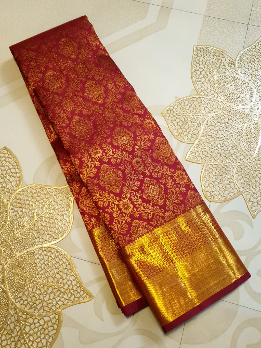 Red Kanchipuram handloom 2G gold pattu silk saree featuring intricate gold brocade weaving and a detailed Lord Murugan pallu.