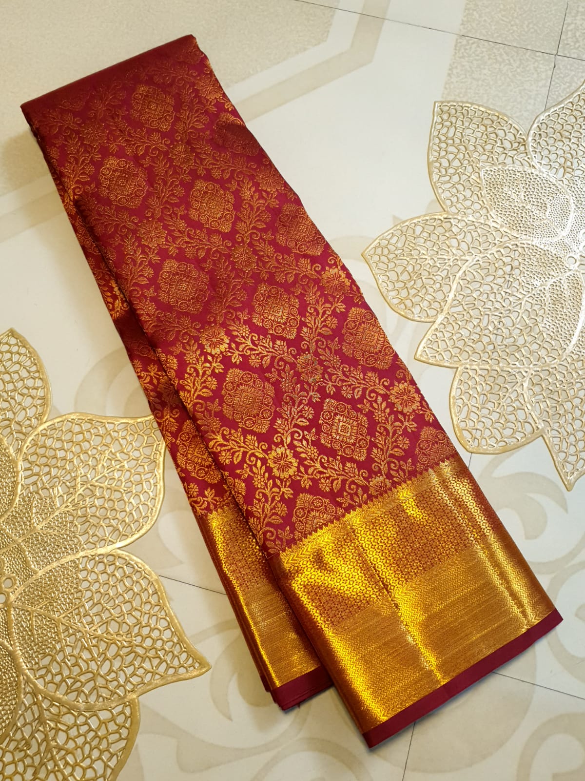 Red Kanchipuram handloom 2G gold pattu silk saree featuring intricate gold brocade weaving and a detailed Lord Murugan pallu.
