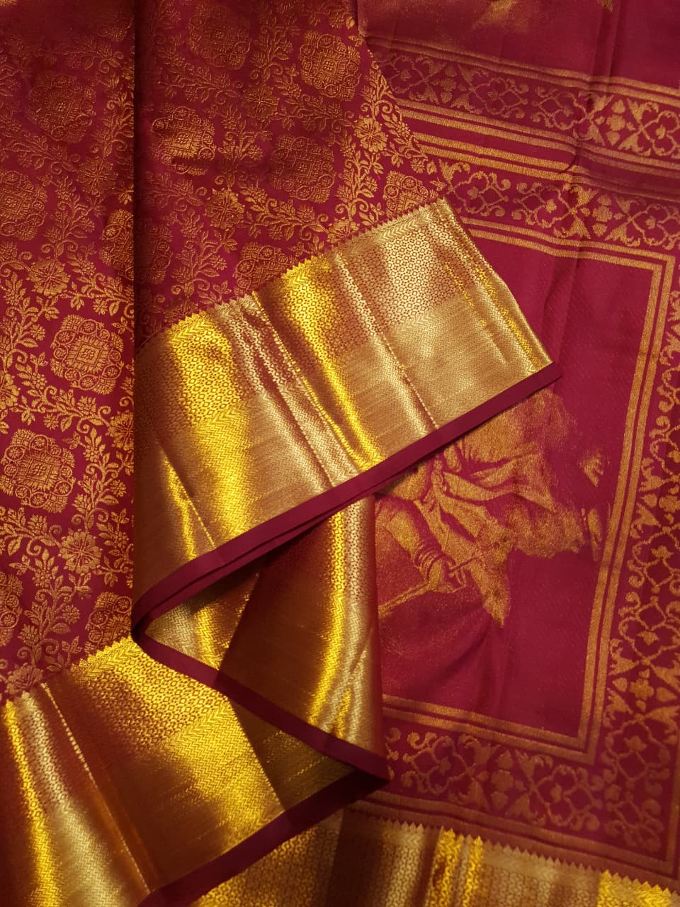 Red Kanchipuram handloom 2G gold pattu silk saree featuring intricate gold brocade weaving and a detailed Lord Murugan pallu.
