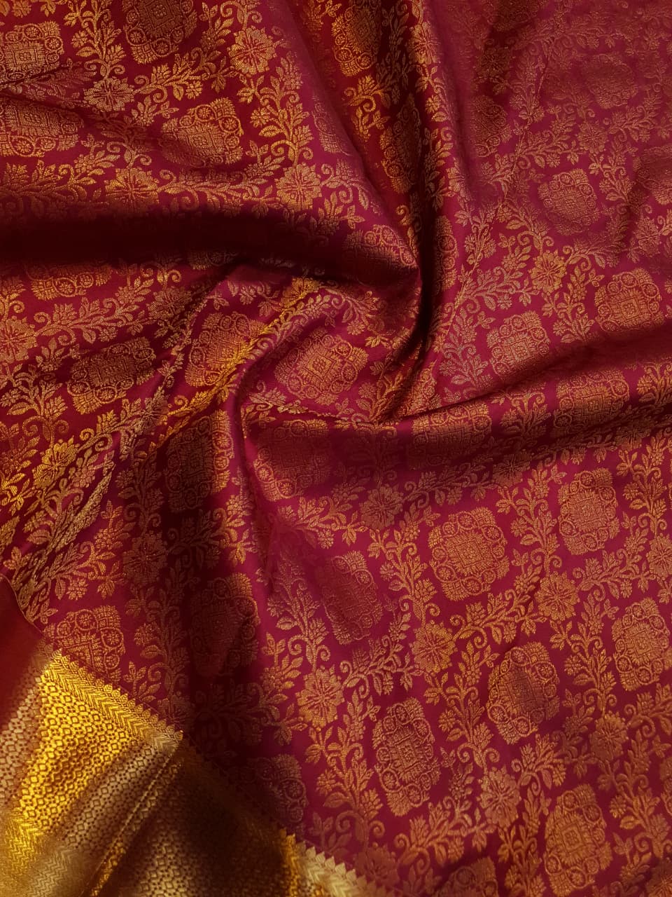 Red Kanchipuram handloom 2G gold pattu silk saree featuring intricate gold brocade weaving and a detailed Lord Murugan pallu.