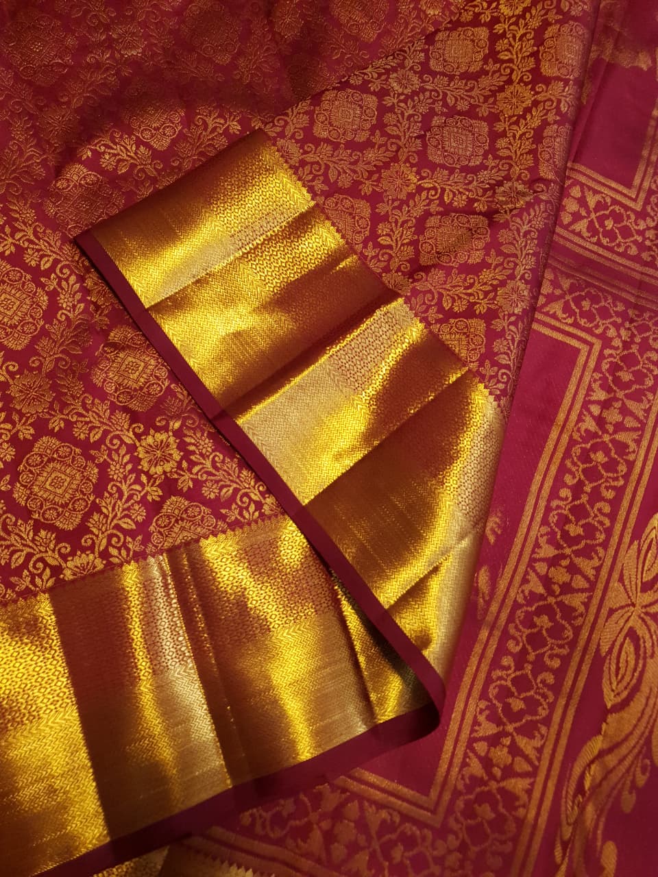 Red Kanchipuram handloom 2G gold pattu silk saree featuring intricate gold brocade weaving and a detailed Lord Murugan pallu.