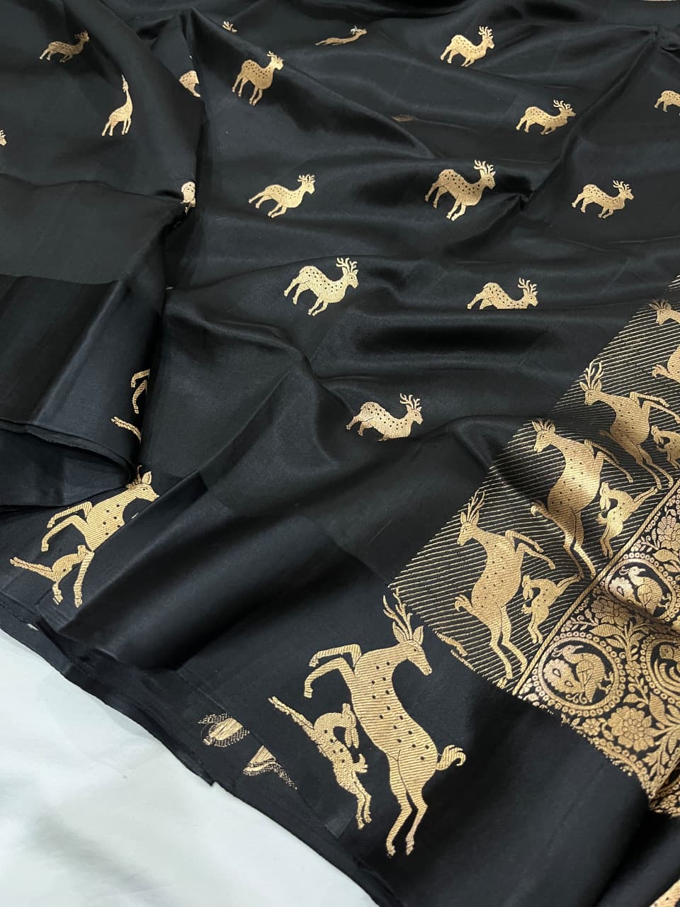 Black Banarasi Handloom Mashru Silk Saree featuring authentic Kaduwa weaving, intricate gold zari deer and animal motifs, a rich traditional Banarasi pallu, Silk Mark Certified pure silk, dyeable to your choice of colors, and includes a running blouse piece—perfect for weddings, festive occasions, and luxury ethnic wear.