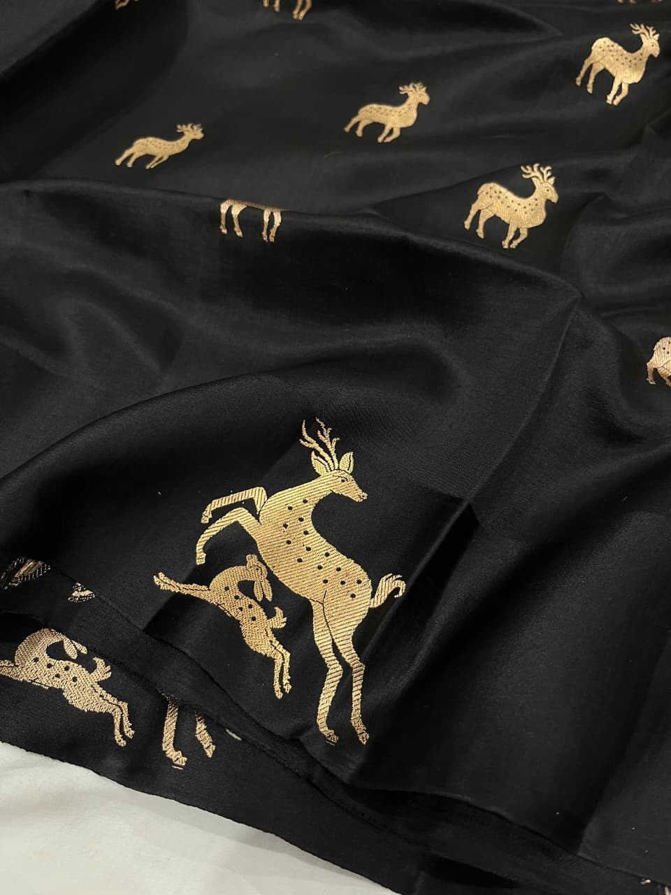 Black Banarasi Handloom Mashru Silk Saree featuring authentic Kaduwa weaving, intricate gold zari deer and animal motifs, a rich traditional Banarasi pallu, Silk Mark Certified pure silk, dyeable to your choice of colors, and includes a running blouse piece—perfect for weddings, festive occasions, and luxury ethnic wear.