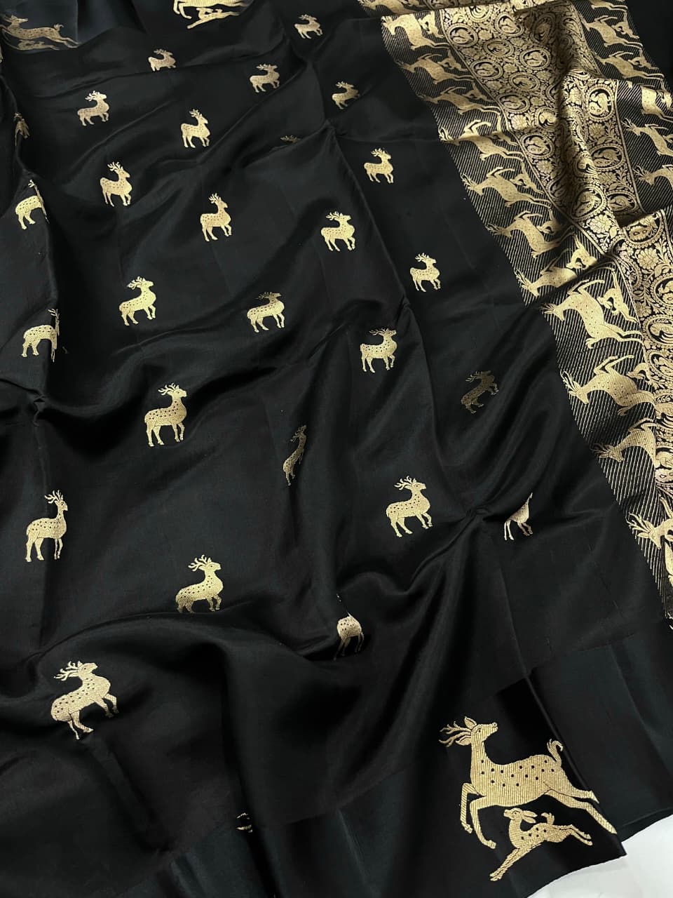 Black Banarasi Handloom Mashru Silk Saree featuring authentic Kaduwa weaving, intricate gold zari deer and animal motifs, a rich traditional Banarasi pallu, Silk Mark Certified pure silk, dyeable to your choice of colors, and includes a running blouse piece—perfect for weddings, festive occasions, and luxury ethnic wear.
