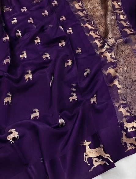 Luxurious purple Mashru silk fabric with detailed gold zari Kaduwa floral and animal motifs, highlighting the authentic handloom craftsmanship.