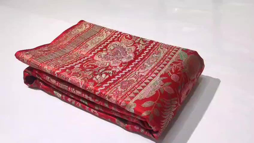 Classic red Kanchipuram handloom tissue brocade silk saree featuring intricate multicolored Meenakari weaving and shimmering pure zari work.