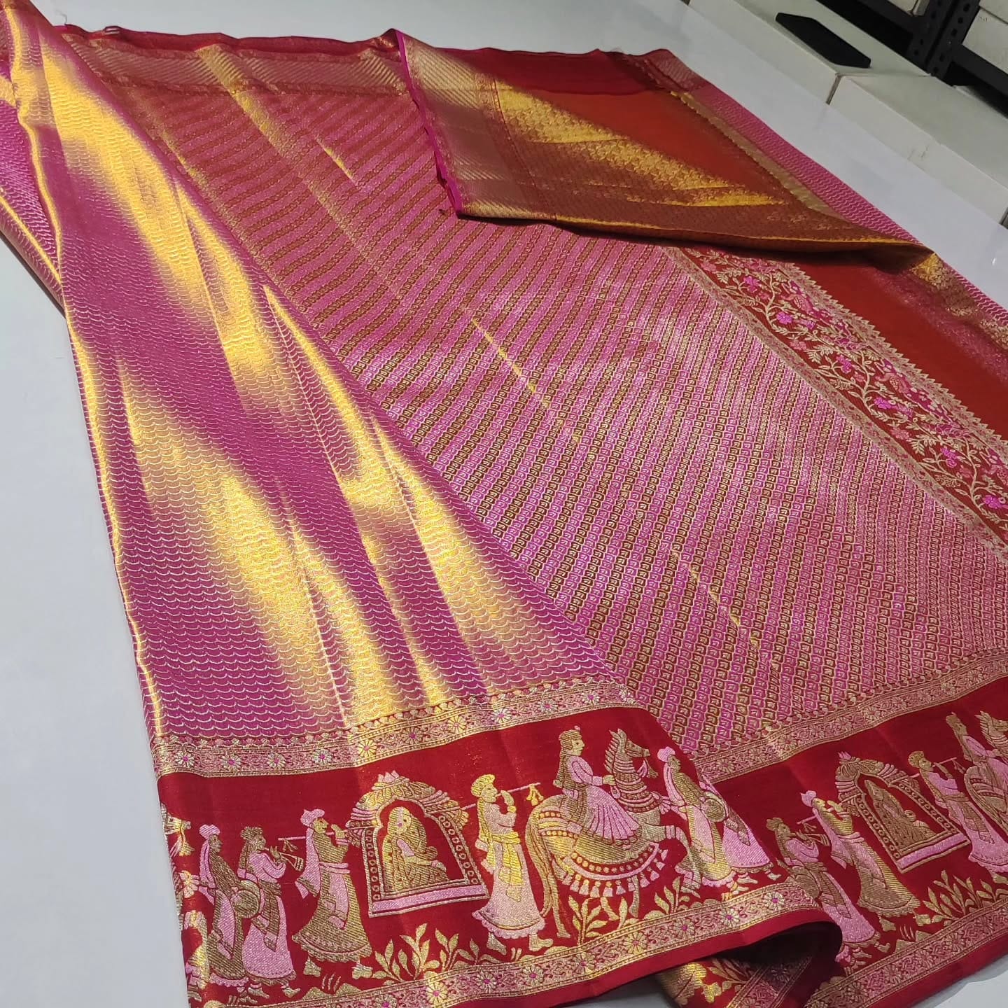 Rani Pink Kanchipuram handloom double warp tissue brocade silk saree with intricate Kalyana Pallakku motifs and a grand rich border.