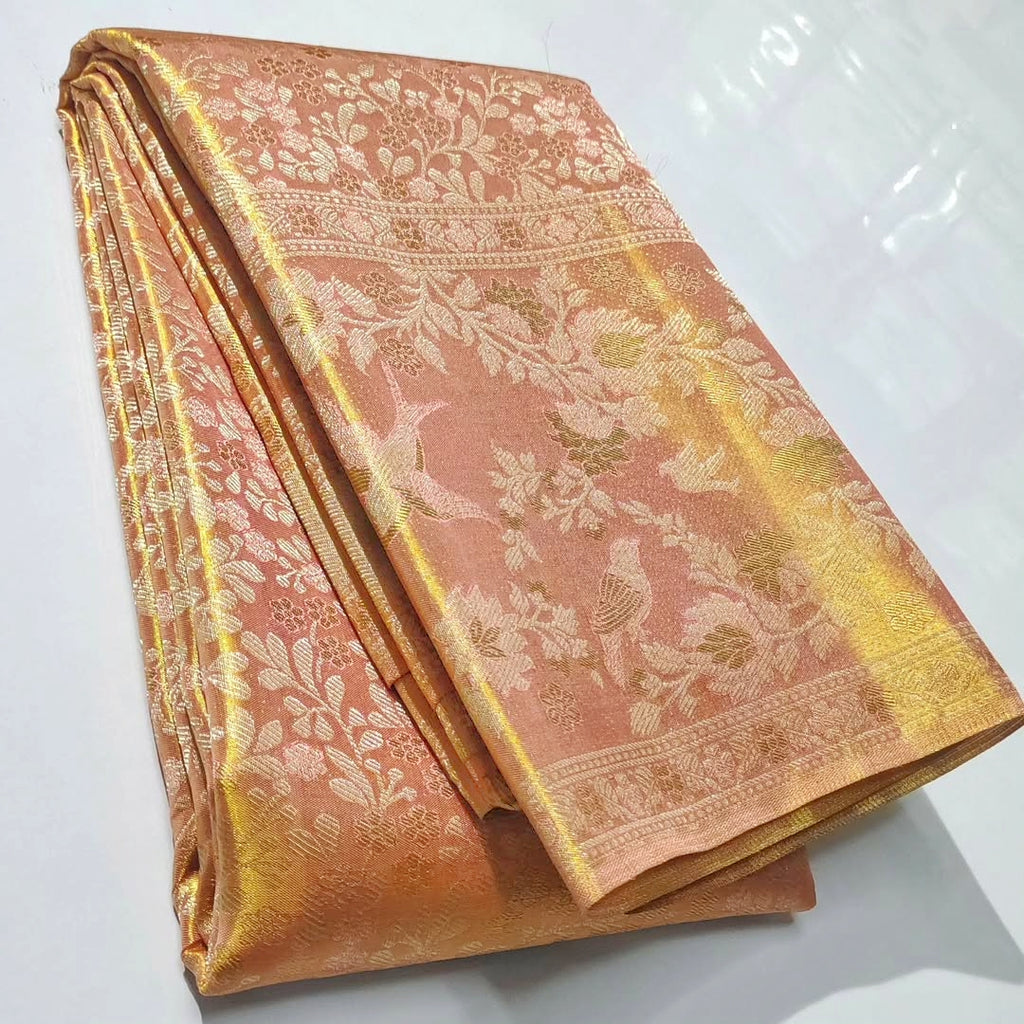 Peach Kanchipuram handloom tissue brocade silk bridal saree featuring an intricate all-over gold woven floral design and traditional zari borders.