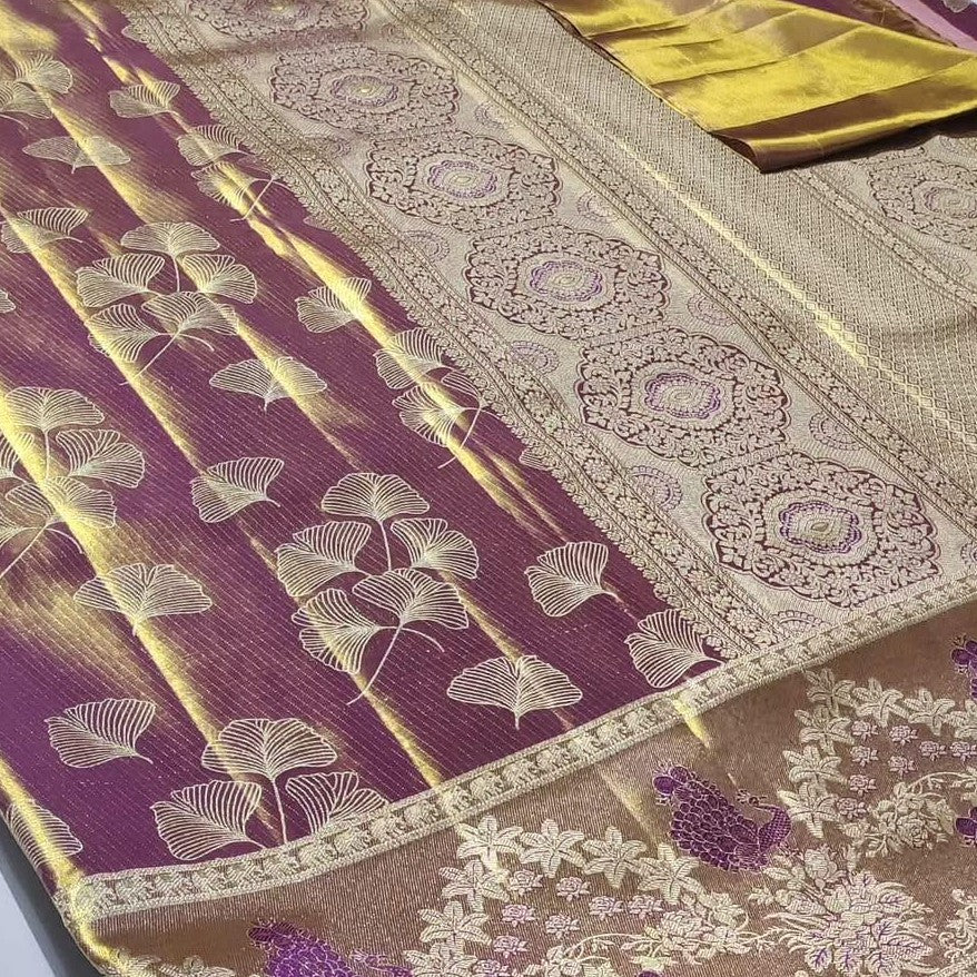 Plum Kanchipuram handloom tissue brocade silk saree with gold tissue sheen, intricate ginkgo leaf body motifs, and an antique gold border featuring floral motifs.