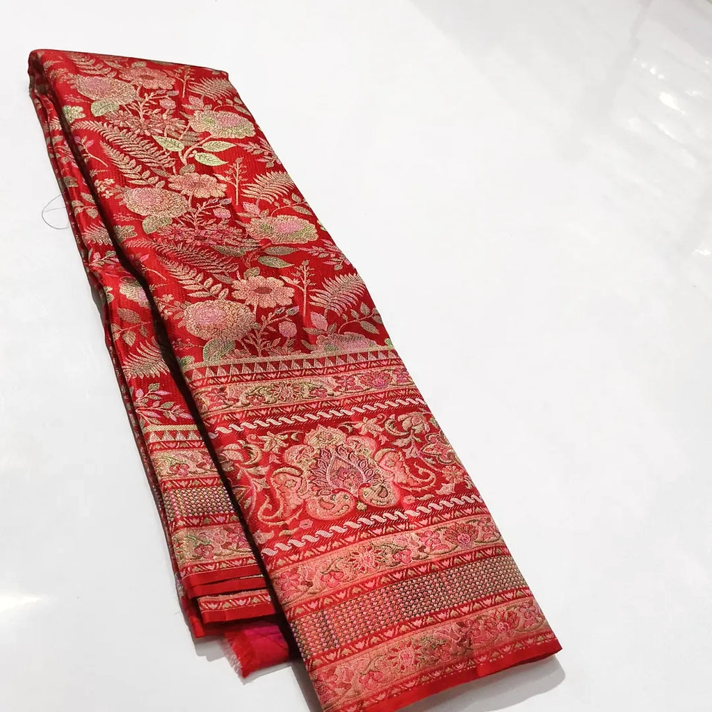Classic red Kanchipuram handloom tissue brocade silk saree featuring intricate multicolored Meenakari weaving and shimmering pure zari work.