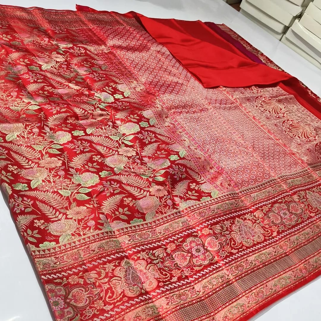 Classic red Kanchipuram handloom tissue brocade silk saree featuring intricate multicolored Meenakari weaving and shimmering pure zari work.