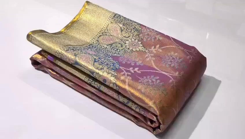 A luxurious Lavender Kanchipuram Handloom Tissue Brocade Silk saree with intricate gold floral patterns and colorful Meenakari detailing throughout the body and pallu.