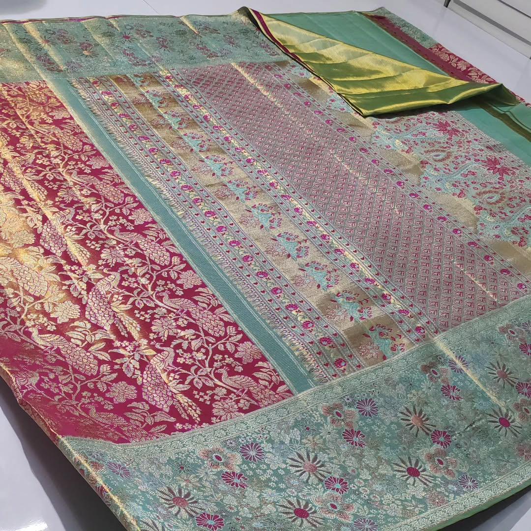 A vibrant Rani Pink Kanchipuram Handloom Tissue Silk Saree featuring a heavy gold tissue finish, all-over floral brocade, and colorful Meenakari accents.