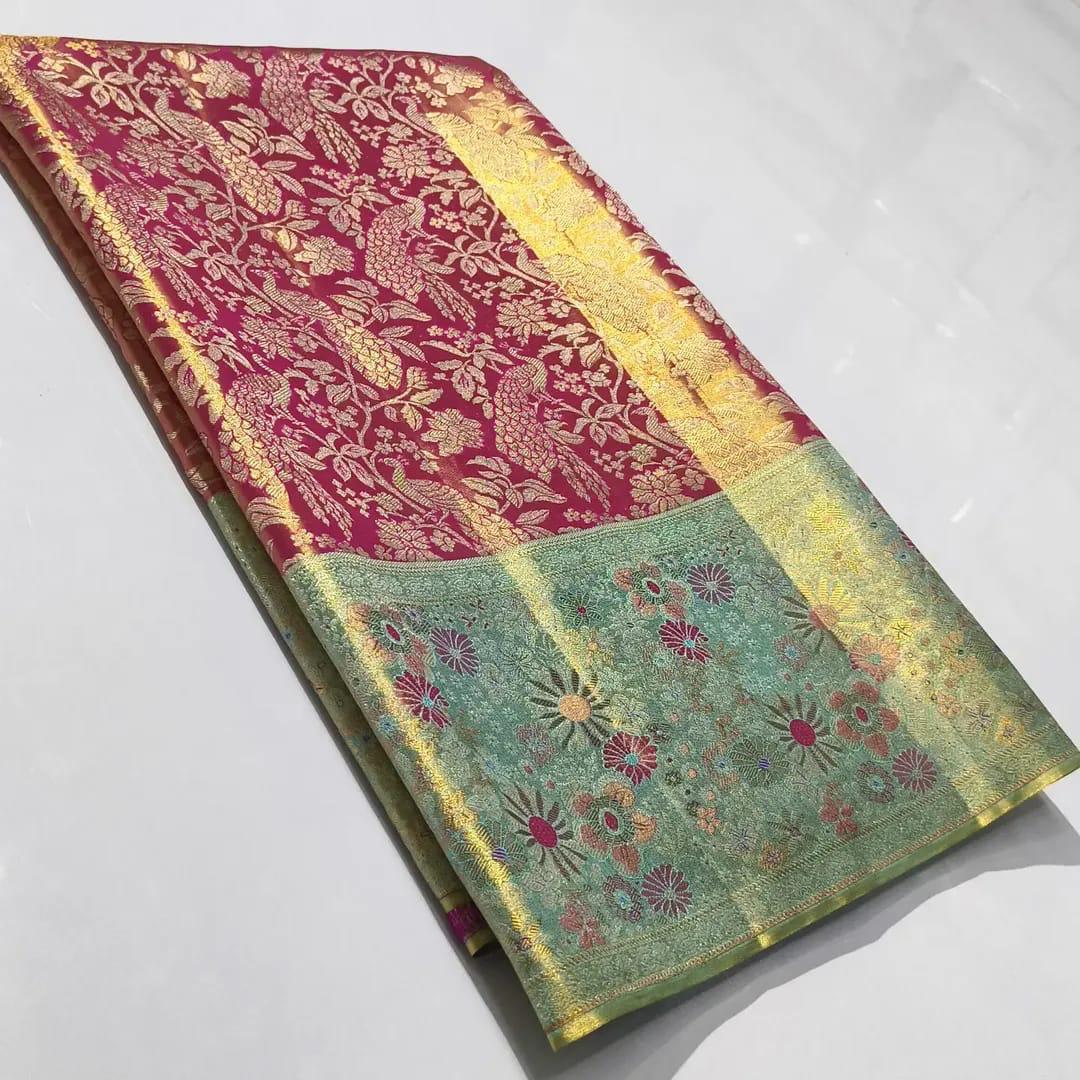 A vibrant Rani Pink Kanchipuram Handloom Tissue Silk Saree featuring a heavy gold tissue finish, all-over floral brocade, and colorful Meenakari accents.