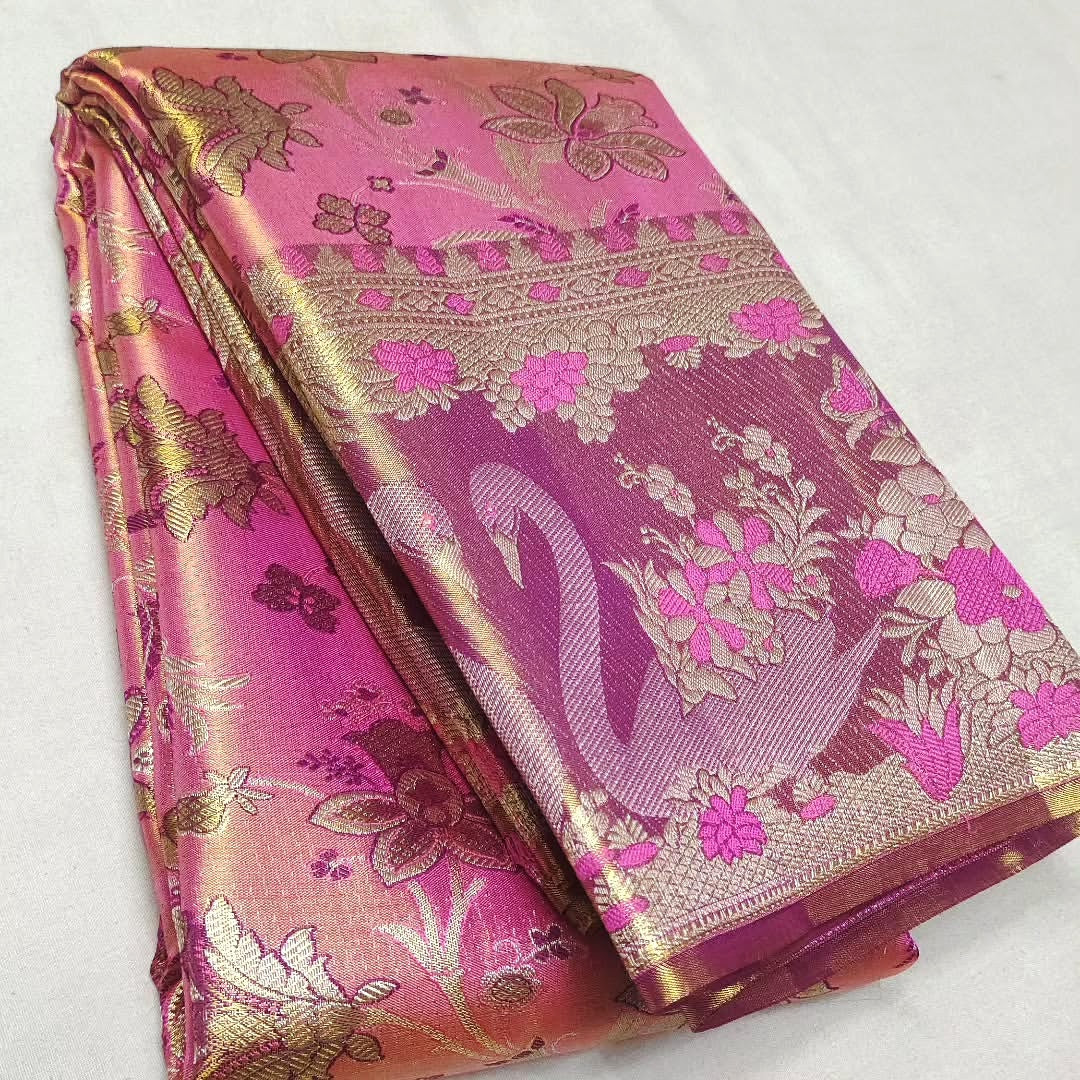 Vibrant hot pink Kanchipuram handloom tissue brocade silk saree featuring intricate Meenakari weaving and shimmering pure zari work.