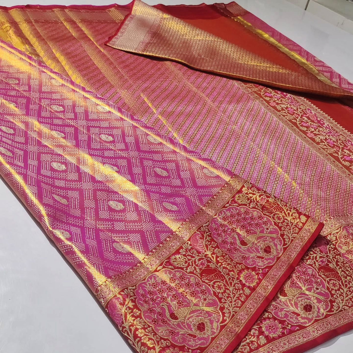 Rani Pink Kanchipuram handloom tissue brocade silk saree with intricate Meenakari floral patterns and a rich golden zari border.