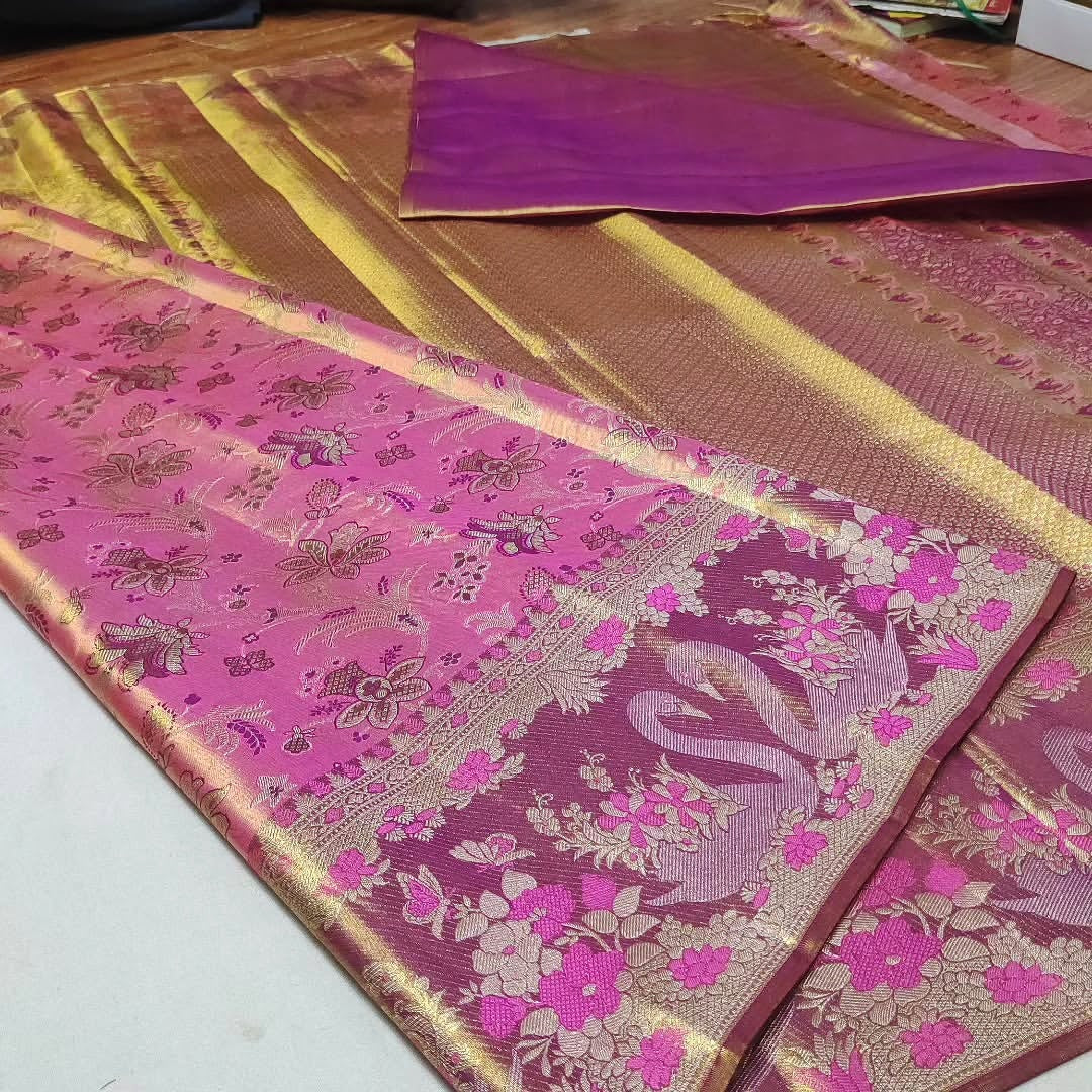 Vibrant hot pink Kanchipuram handloom tissue brocade silk saree featuring intricate Meenakari weaving and shimmering pure zari work.