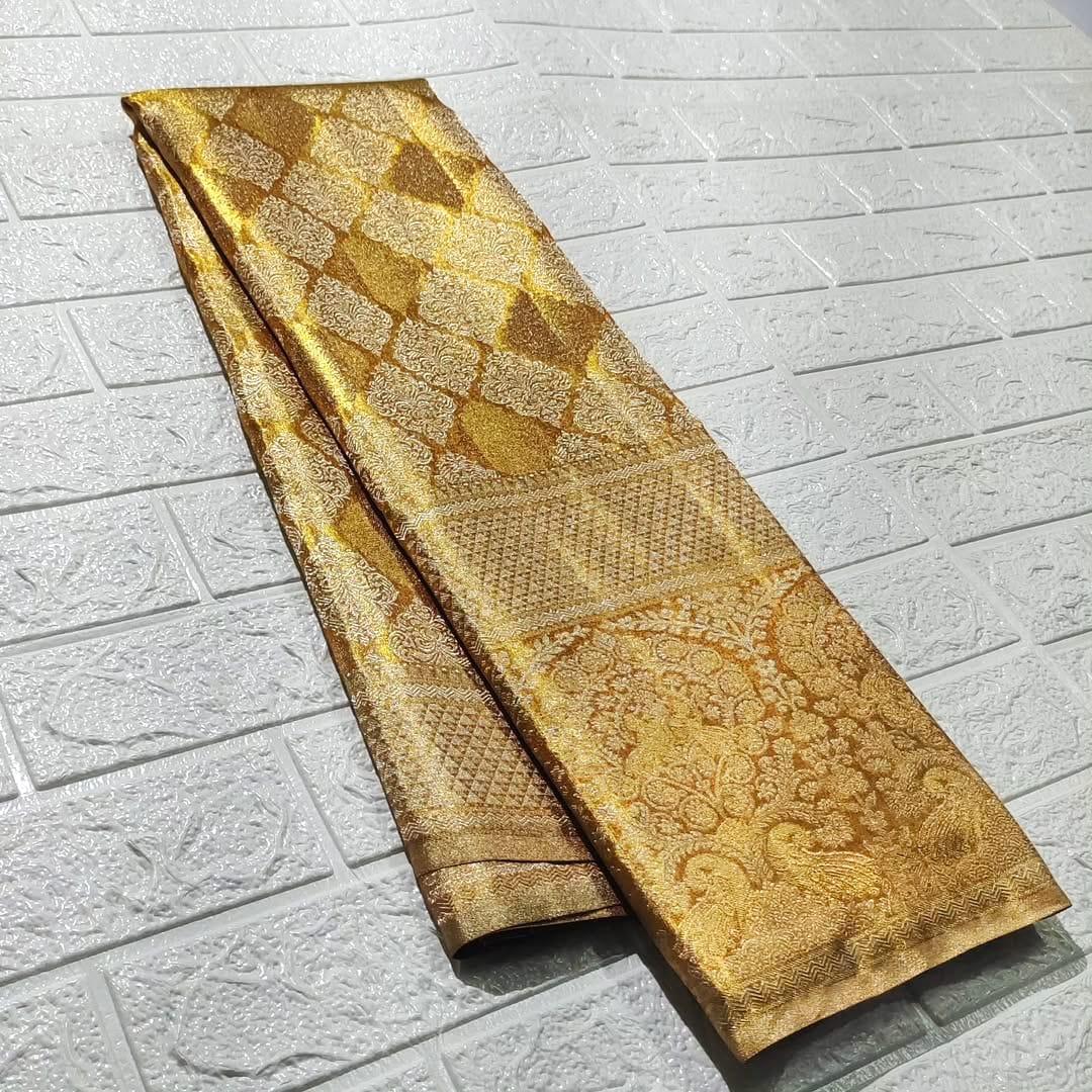 Gold Kanchipuram Tissue Silk saree featuring intricate edge-to-edge checks and floral butta embroidery.