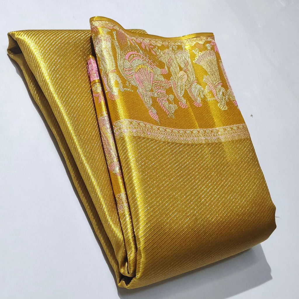 Luminous gold Kanchipuram handloom tissue brocade silk saree featuring intricate zari weaving and a grand Kalyana Pallakku design.