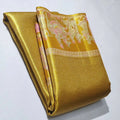 Luminous gold Kanchipuram handloom tissue brocade silk saree featuring intricate zari weaving and a grand Kalyana Pallakku design.