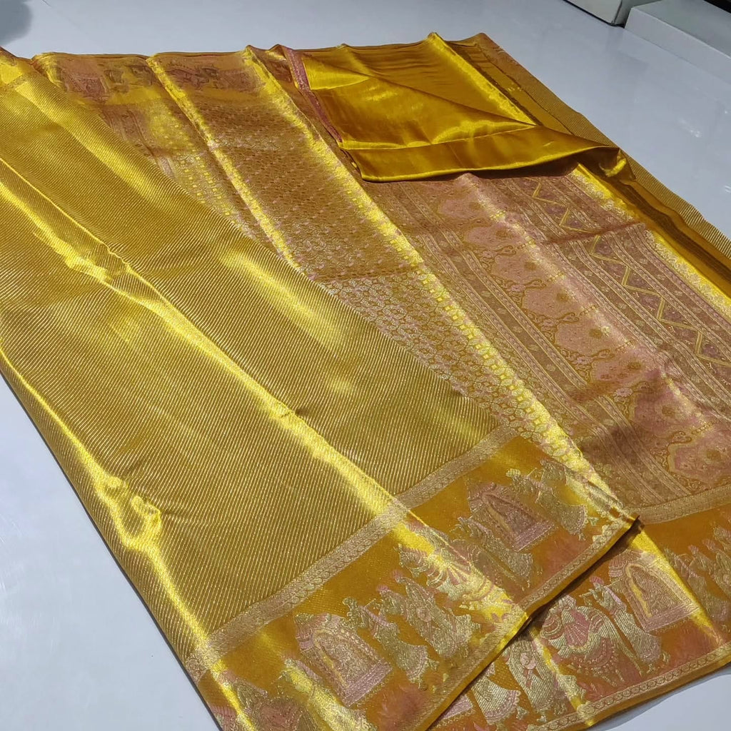 Luminous gold Kanchipuram handloom tissue brocade silk saree featuring intricate zari weaving and a grand Kalyana Pallakku design.