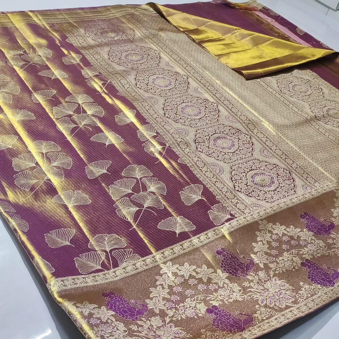 Plum Kanchipuram handloom tissue brocade silk saree with gold tissue sheen, intricate ginkgo leaf body motifs, and an antique gold border featuring floral motifs.