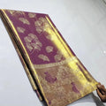 Plum Kanchipuram handloom tissue brocade silk saree with gold tissue sheen, intricate ginkgo leaf body motifs, and an antique gold border featuring floral motifs.