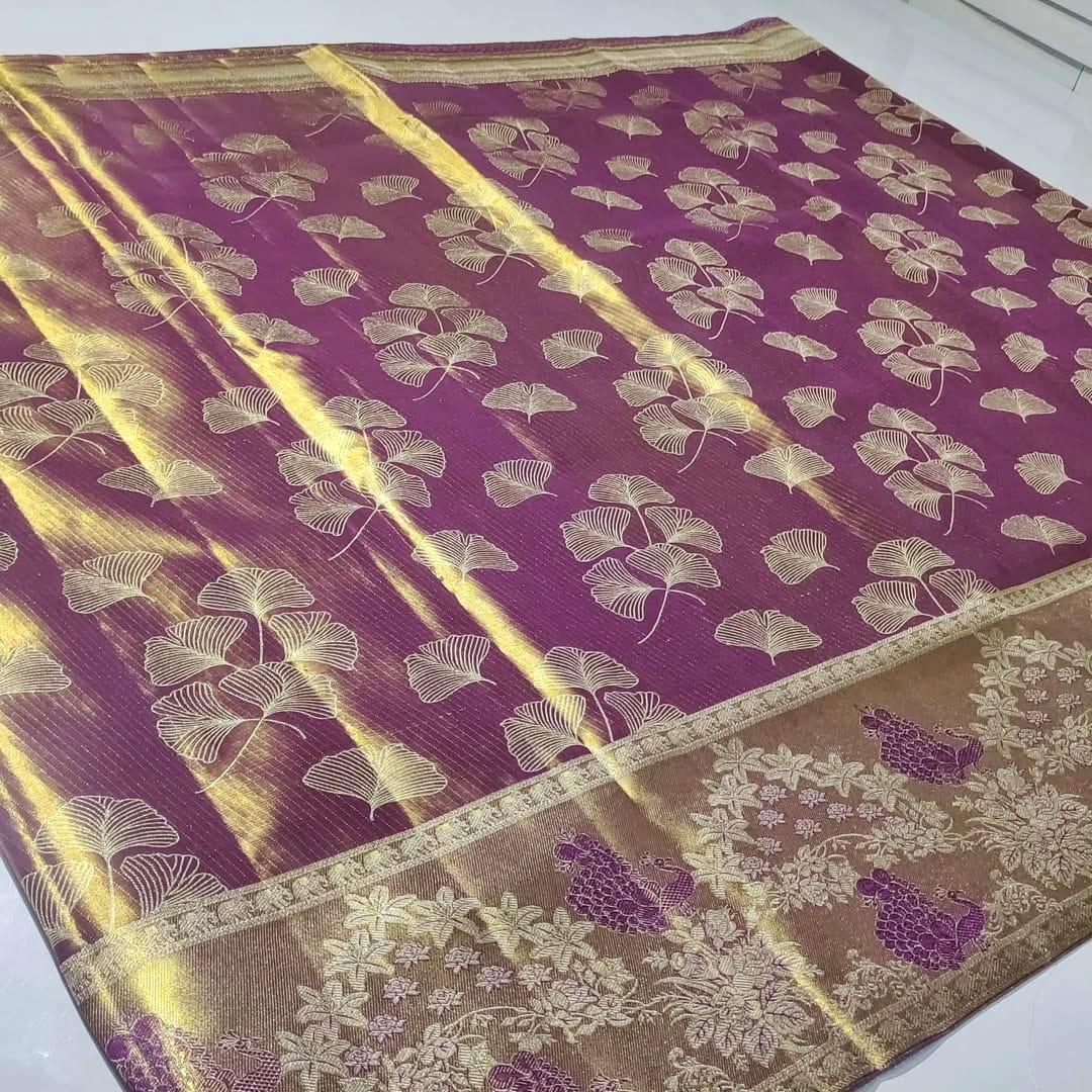 Plum Kanchipuram handloom tissue brocade silk saree with gold tissue sheen, intricate ginkgo leaf body motifs, and an antique gold border featuring floral motifs.