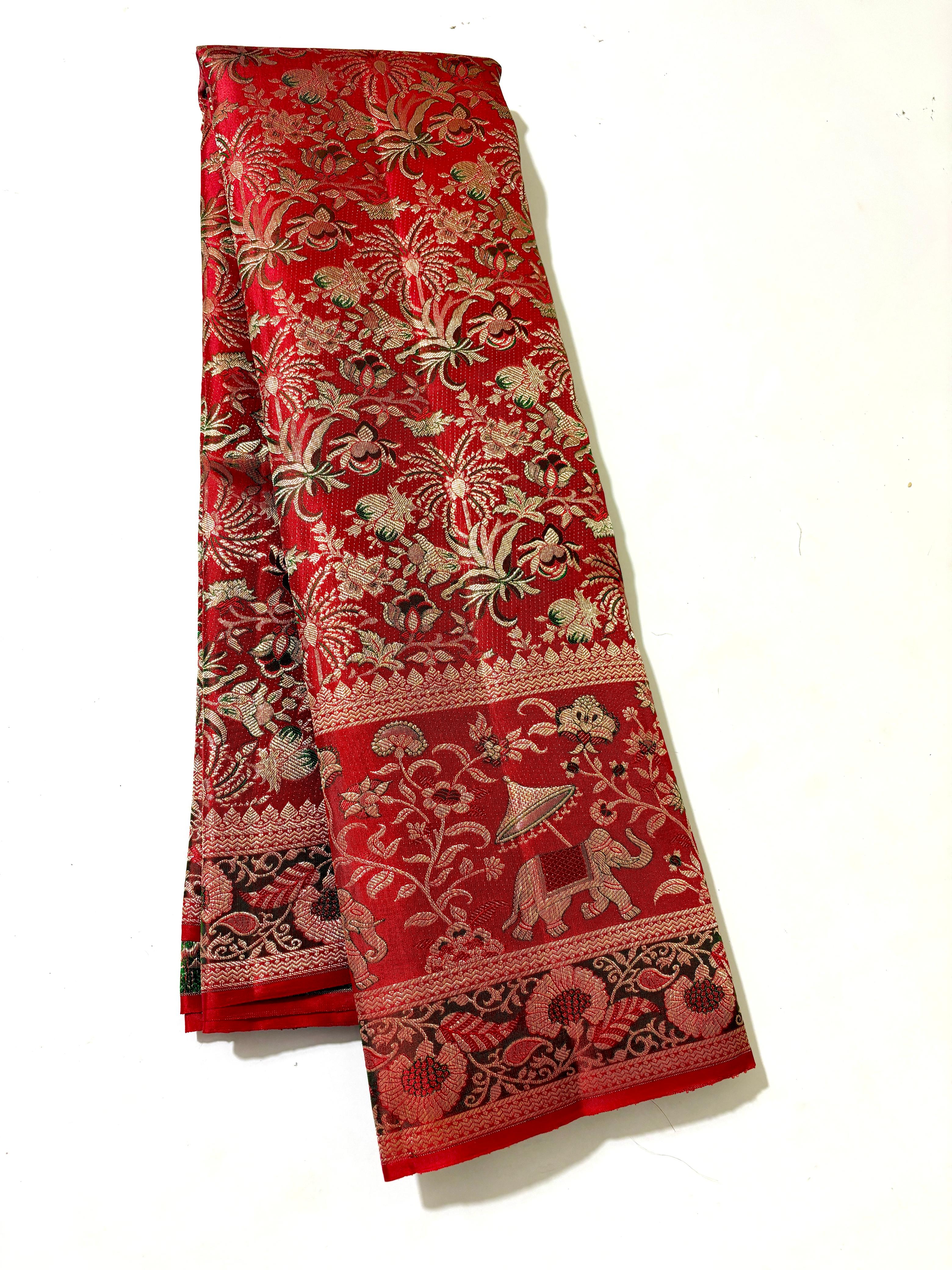 Vibrant red Kanchipuram handloom silk saree featuring detailed 1G gold brocade and multicolored Resham Meenakari work including elephant and floral vine patterns.