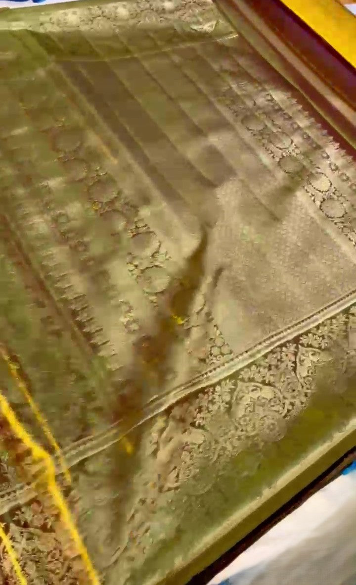 Brown Kanchipuram handloom tissue silk saree featuring intricate metallic brocade work and colorful Meenakari floral details.