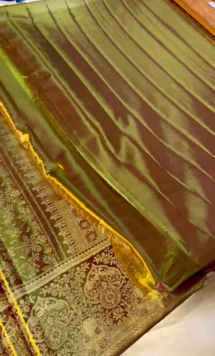 Brown Kanchipuram handloom tissue silk saree featuring intricate metallic brocade work and colorful Meenakari floral details.