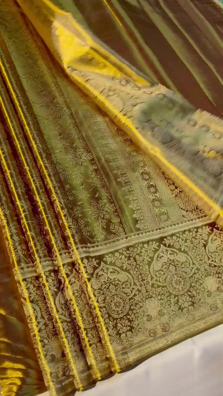 Brown Kanchipuram handloom tissue silk saree featuring intricate metallic brocade work and colorful Meenakari floral details.