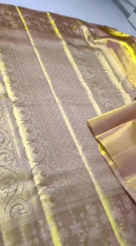 A close-up of a luxurious gold Kanchipuram tissue silk saree featuring intricate metallic brocade weaving, authentic Silk Mark certification, and a grand bridal luster.