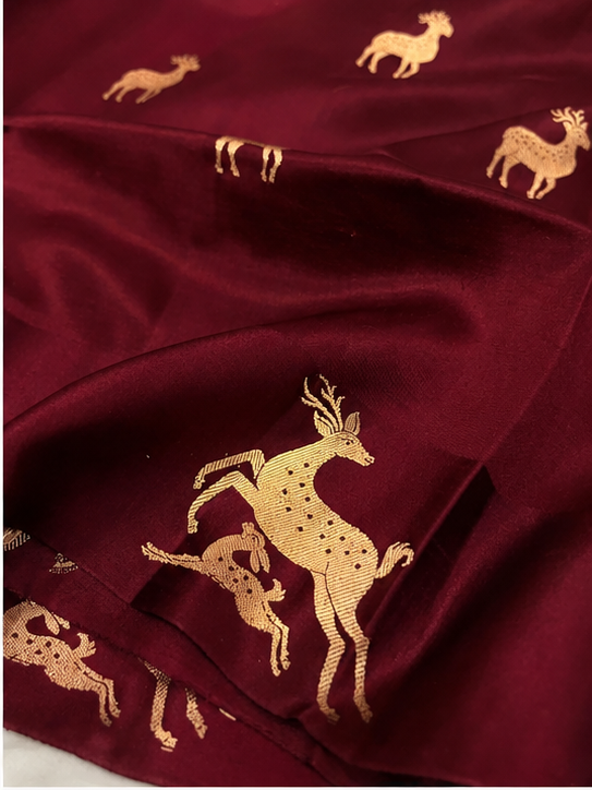 Plum Banarasi Handloom Mashru Silk Saree featuring authentic Kaduwa weaving, intricate gold zari deer and animal motifs, a rich traditional Banarasi pallu, Silk Mark Certified pure silk, dyeable to your choice of colors, and a matching running blouse piece, perfect for weddings and festive occasions.