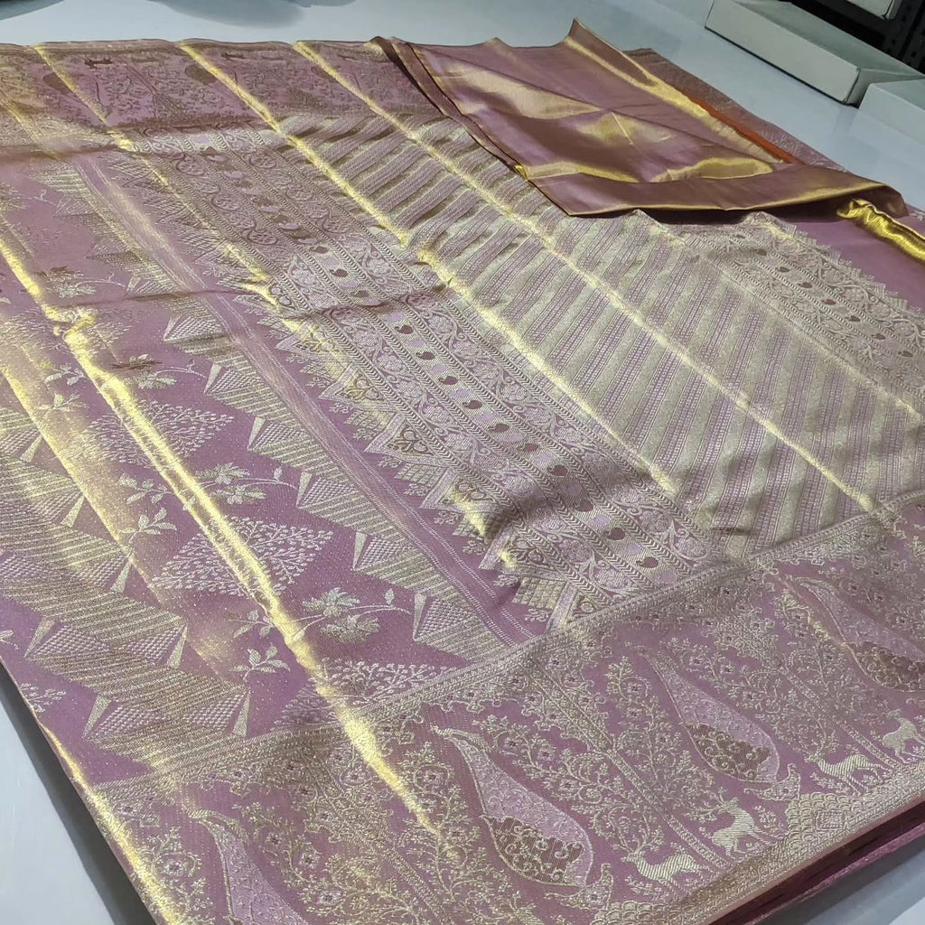 Close-up of the baby pink Kanchipuram tissue silk saree showcasing intricate gold brocade patterns and edge-to-edge Meenakari work.
