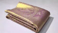 Close-up of the baby pink Kanchipuram tissue silk saree showcasing intricate gold brocade patterns and edge-to-edge Meenakari work.