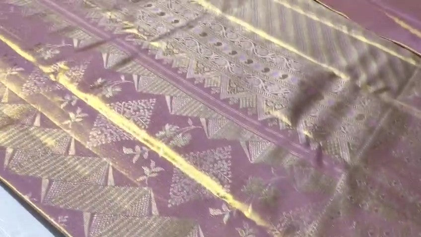 Close-up of the baby pink Kanchipuram tissue silk saree showcasing intricate gold brocade patterns and edge-to-edge Meenakari work.
