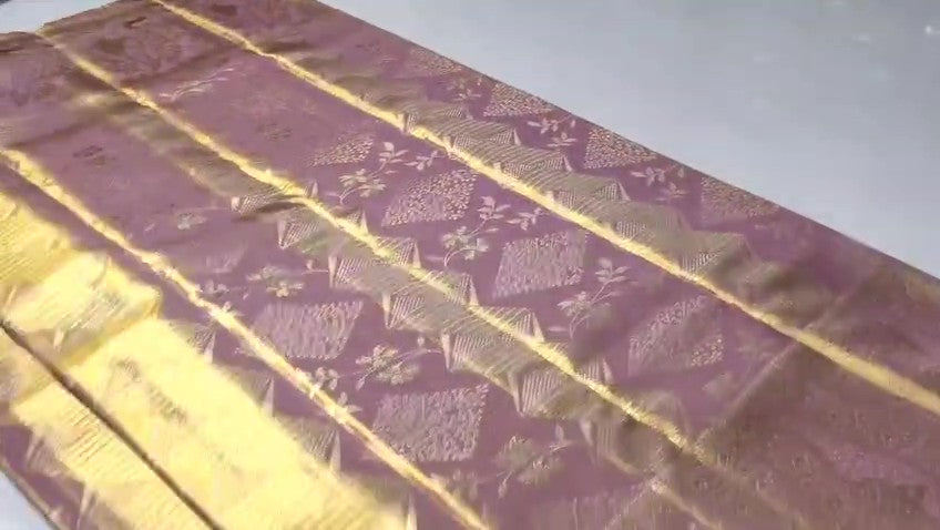 Close-up of the baby pink Kanchipuram tissue silk saree showcasing intricate gold brocade patterns and edge-to-edge Meenakari work.